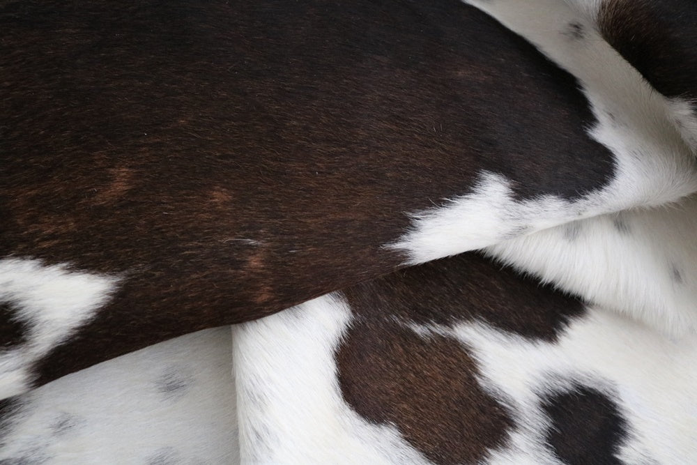 brown chocolate and white cowhide rug