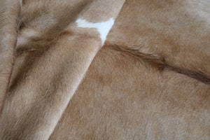 Brown and white cowhide rug. Code 96134.