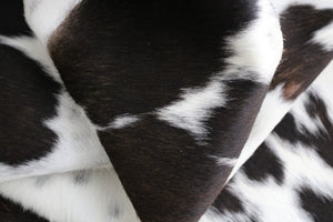 brown and white cowhide rug